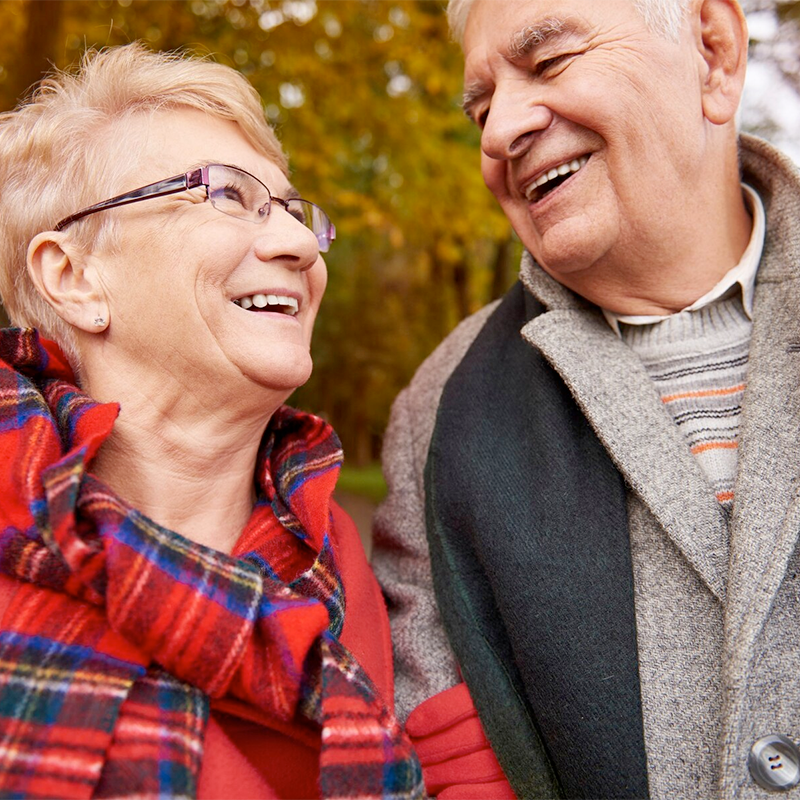 Senior Adult Couple smiling at one another